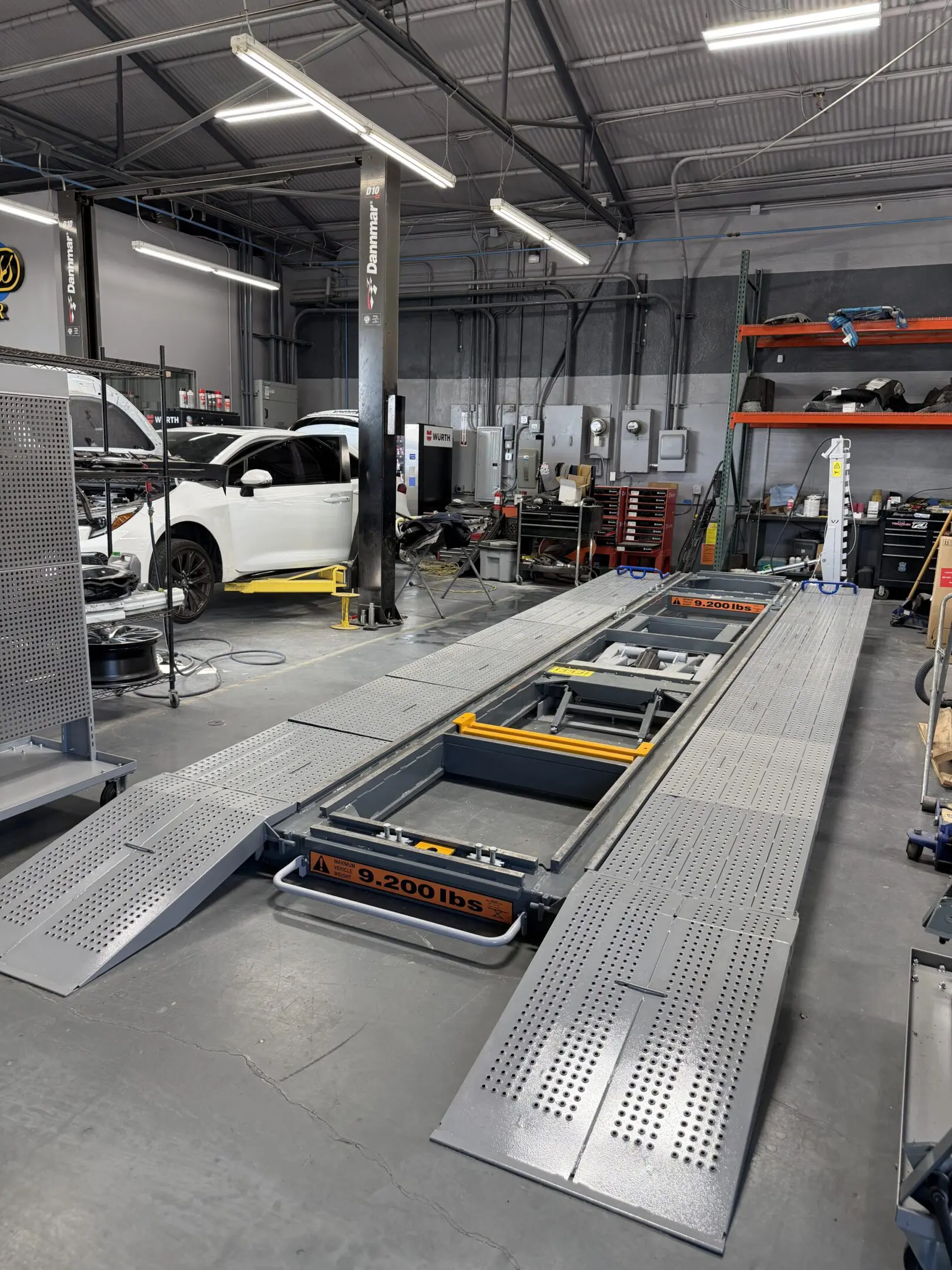 Electric vehicle battery pack being assembled on a production line.